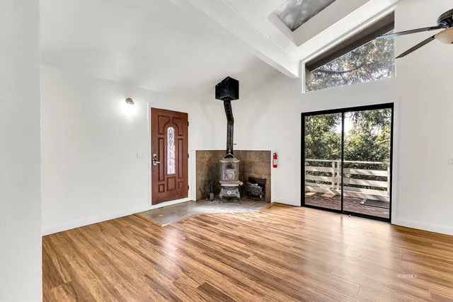 a bathroom with a granite countertop shower sink vanity mirror and toilet
