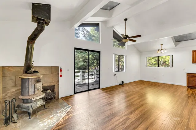 a view of room with wooden floor and furniture