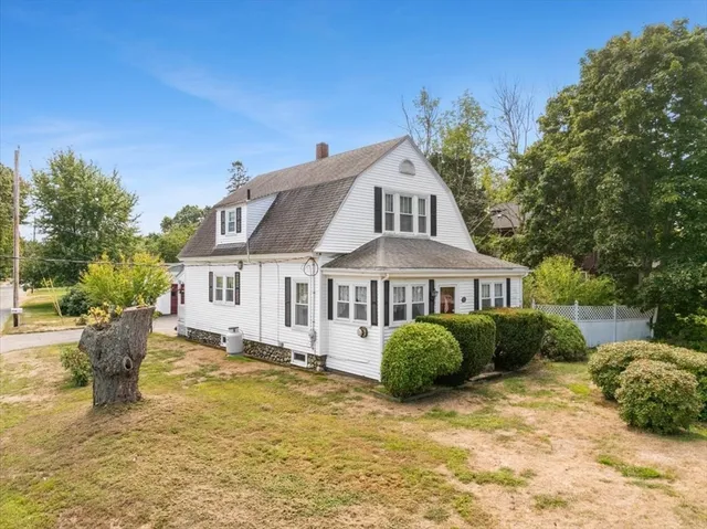 a front view of a house with a garden