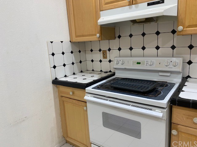 212 South Kraemer Boulevard, Unit 1205 Placentia, CA 92870 - Photo 5 of 11 a white stove top oven sitting inside of a kitchen