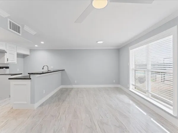 a view of a kitchen with a sink and wooden floor