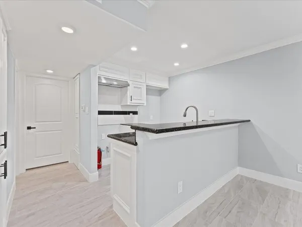 a kitchen with a sink stainless steel appliances and cabinets