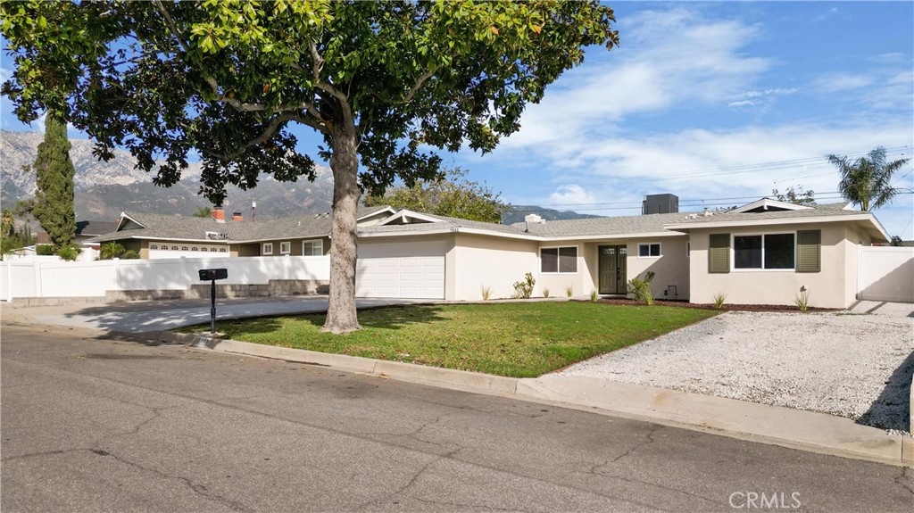 7041 Cameo Street Rancho Cucamonga, CA 91701 - Photo 1 of 1 a view of a white house next to a yard and a road