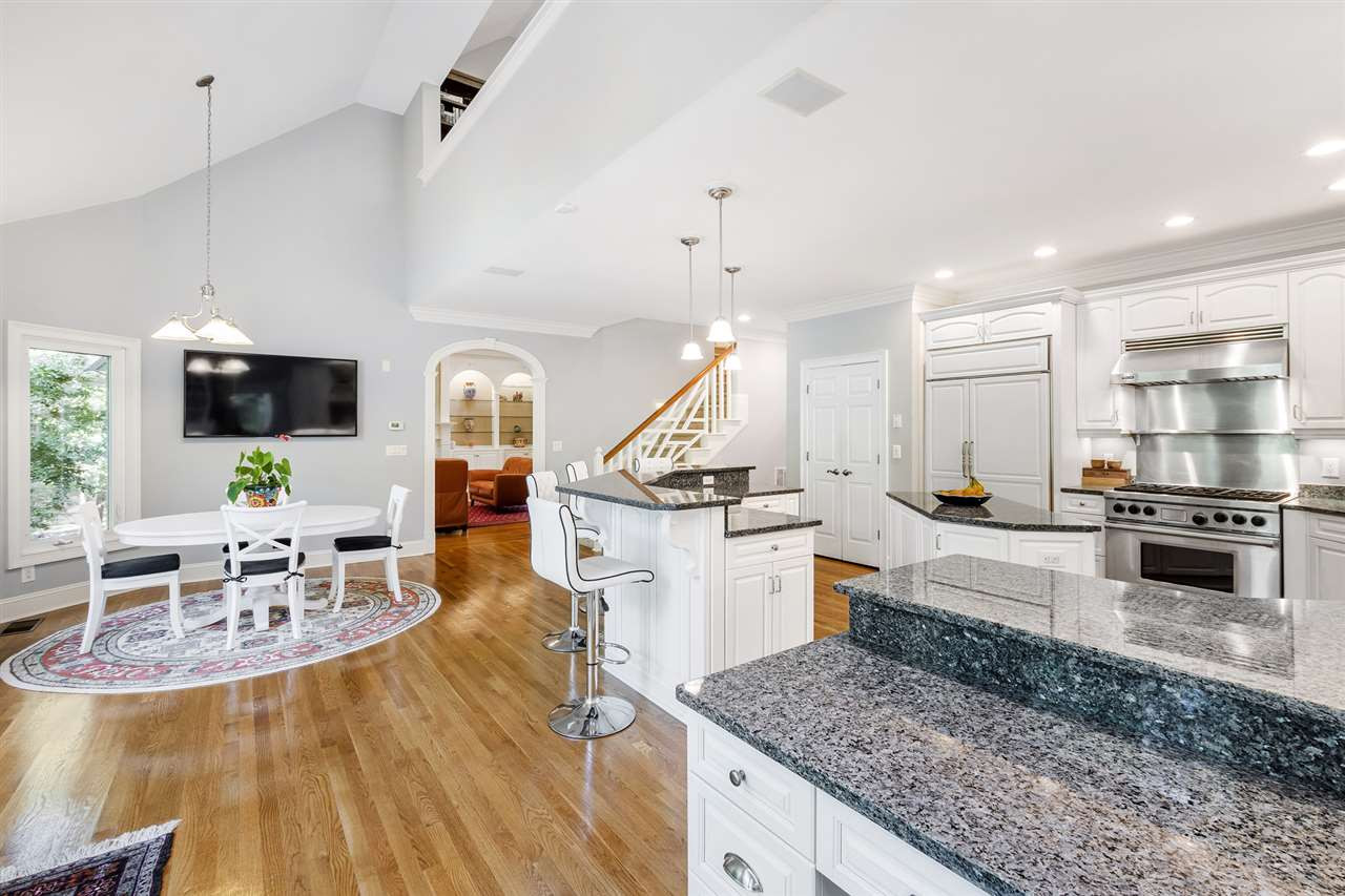 1102 Stonebridge Drive Durham, NC 27712 - Photo 11 of 30 a large kitchen with stainless steel appliances kitchen island granite countertop a large center island and a stove