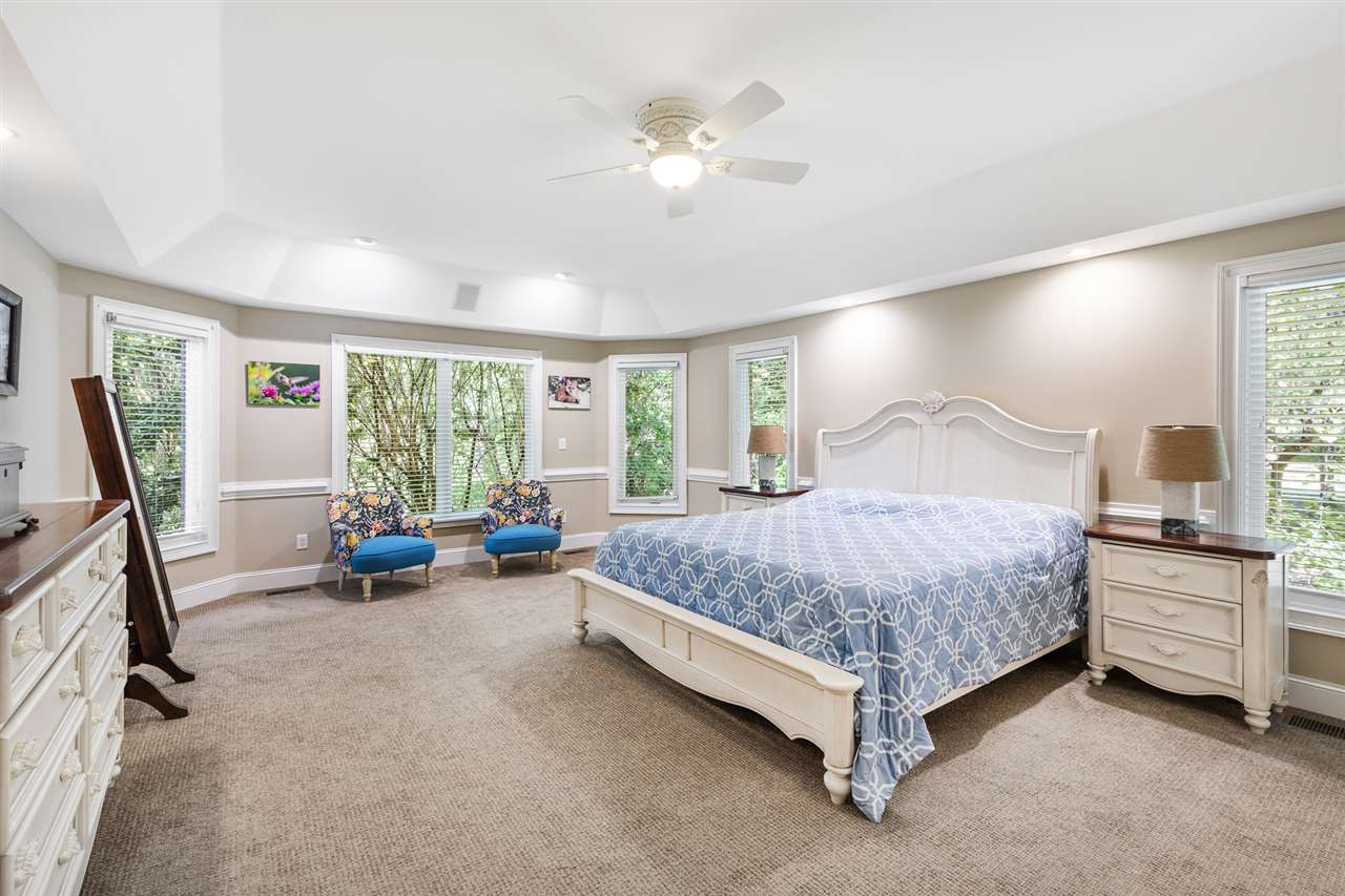 1102 Stonebridge Drive Durham, NC 27712 - Photo 14 of 30 a bedroom with a bed a couch and a large window