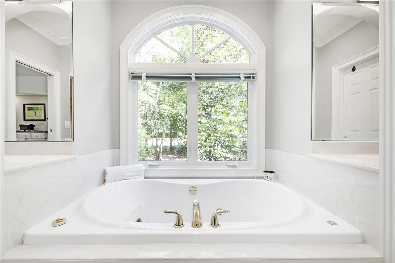 1102 Stonebridge Drive Durham, NC 27712 - Photo 16 of 30 a white bath tub sitting in a bathroom next to a window