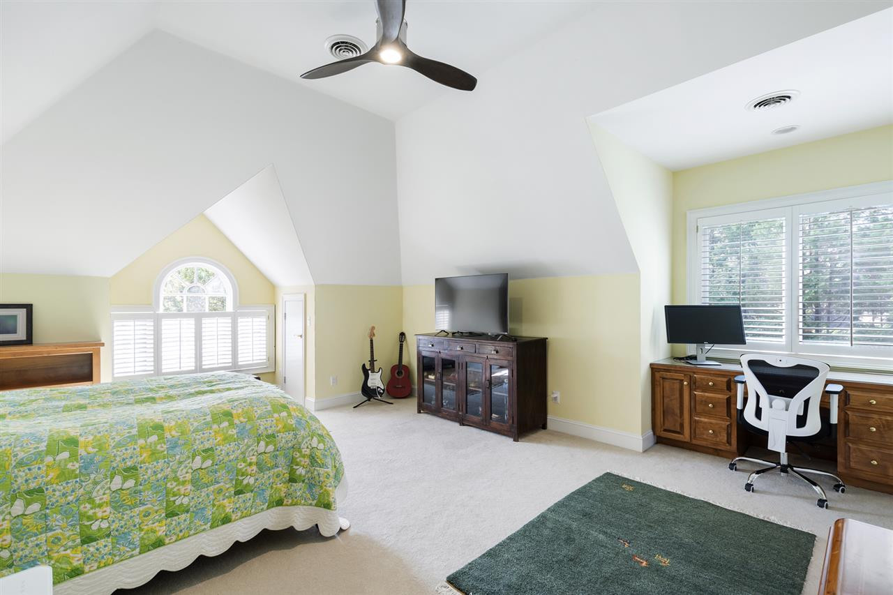 1102 Stonebridge Drive Durham, NC 27712 - Photo 18 of 30 a bedroom with a bed a chair and piano next to a large window
