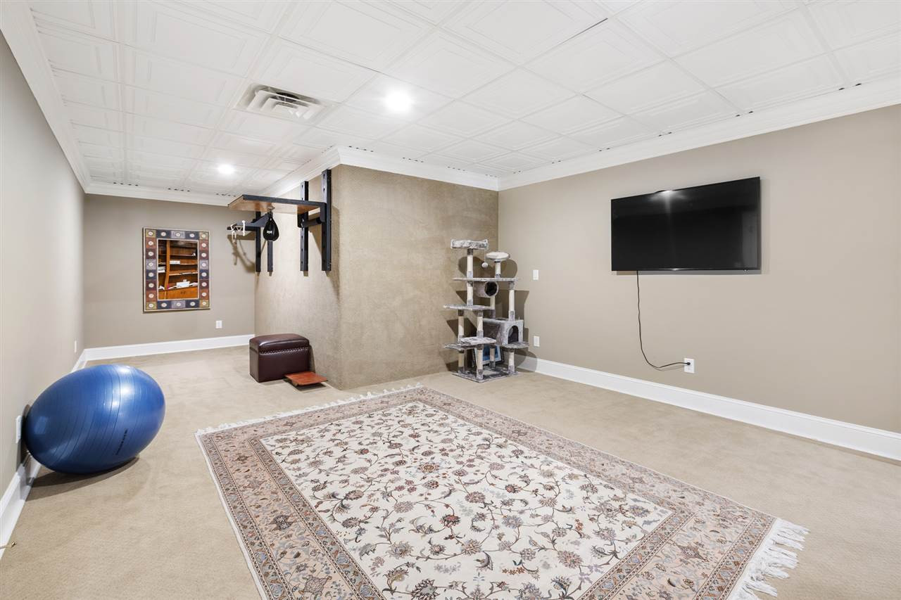 1102 Stonebridge Drive Durham, NC 27712 - Photo 23 of 30 a living room with furniture and a flat screen tv
