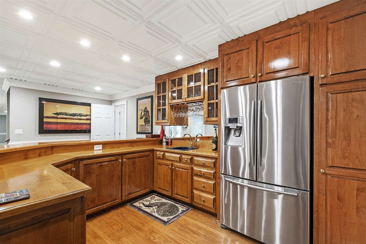 1102 Stonebridge Drive Durham, NC 27712 - Photo 25 of 30 a kitchen with stainless steel appliances granite countertop a refrigerator and a sink