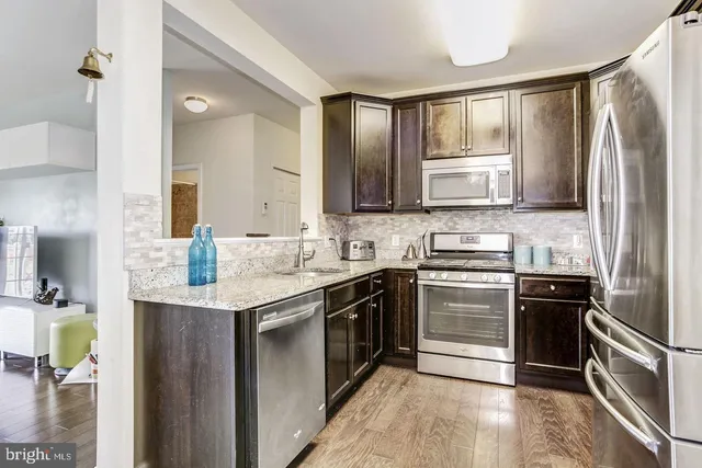 a kitchen with a sink stove and refrigerator