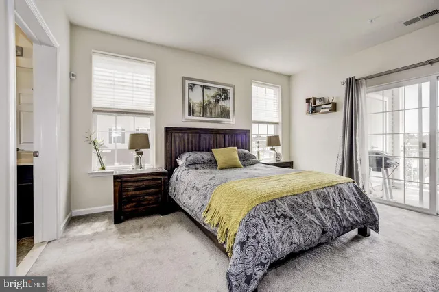 a bedroom with a bed and a large window