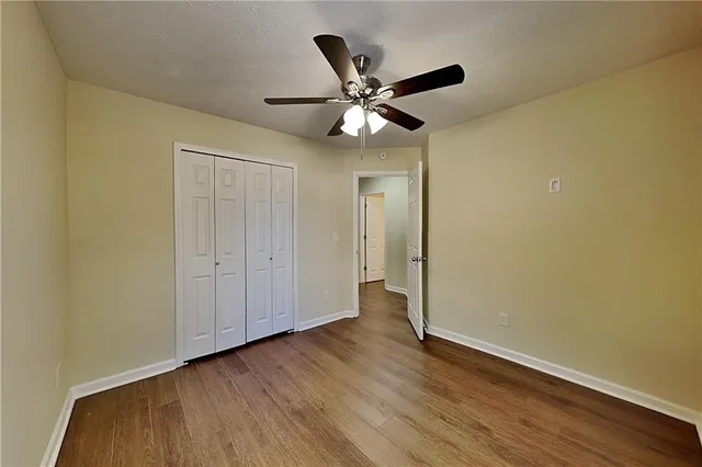 a view of an empty room and wooden floor