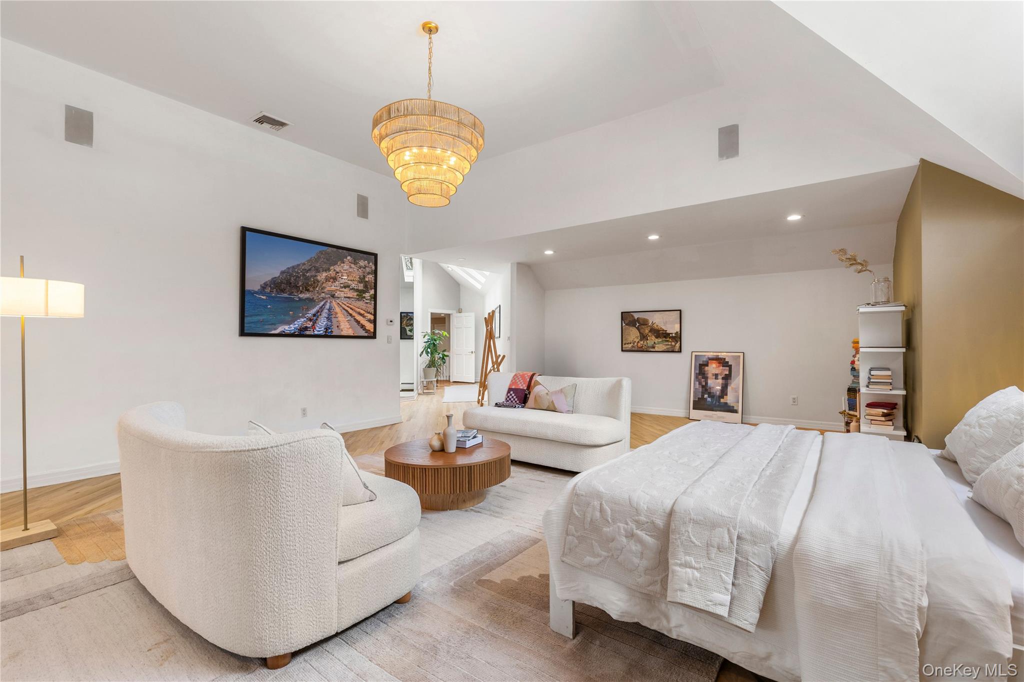 205 Polly Park Road Rye, NY 10580 - Photo 16 of 33 a spacious bedroom with a bed and a chandelier