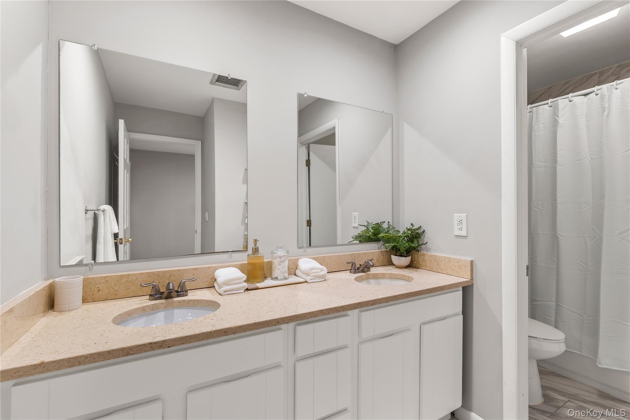 205 Polly Park Road Rye, NY 10580 - Photo 23 of 33 a bathroom with a granite countertop sink and a mirror