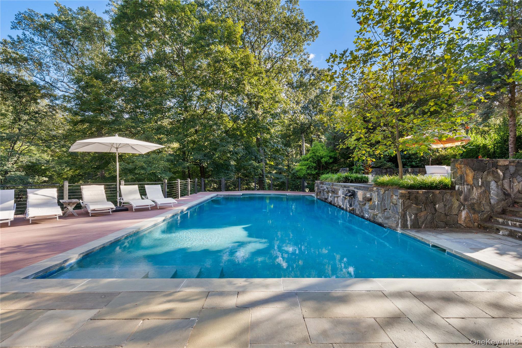 205 Polly Park Road Rye, NY 10580 - Photo 30 of 33 a view of a swimming pool with a patio
