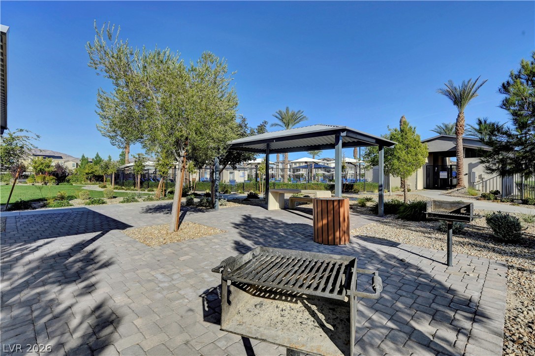 6924 Spicy Merlot Street North Las Vegas, NV 89086 - Photo 69 of 83 A community gathering space features a covered picnic area with built-in seating and a nearby barbecue.