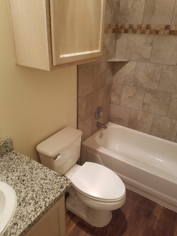 200 Riverbend Drive Georgetown, TX 78628 - Photo 11 of 17 a bathroom with a granite countertop toilet and a bathtub