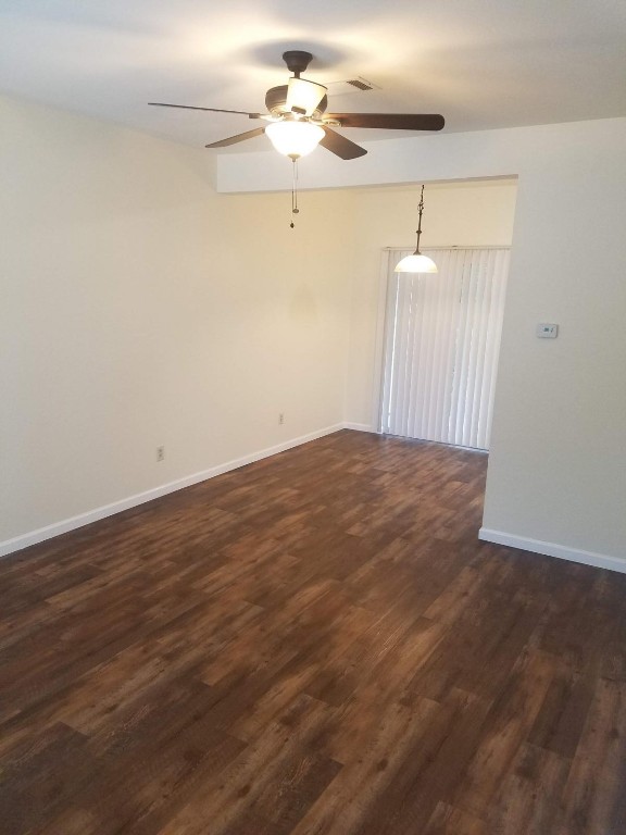 200 Riverbend Drive Georgetown, TX 78628 - Photo 2 of 17 a view of an empty room with a ceiling fan and wooden floor