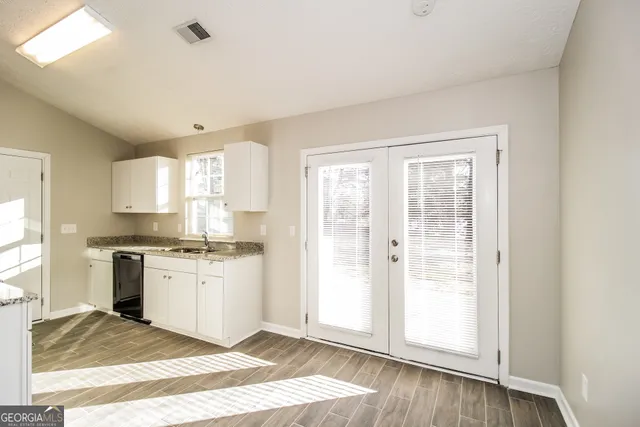 a kitchen with a stove a sink and a refrigerator