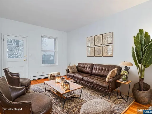 a living room with furniture and a potted plant