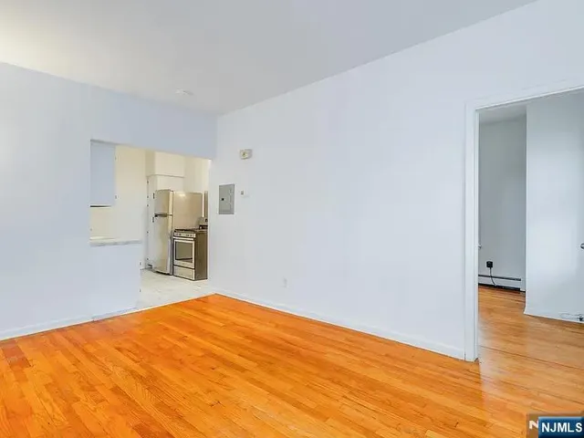 a room with a bed and wooden floor