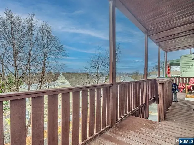 a wooden bench sitting in front of a building