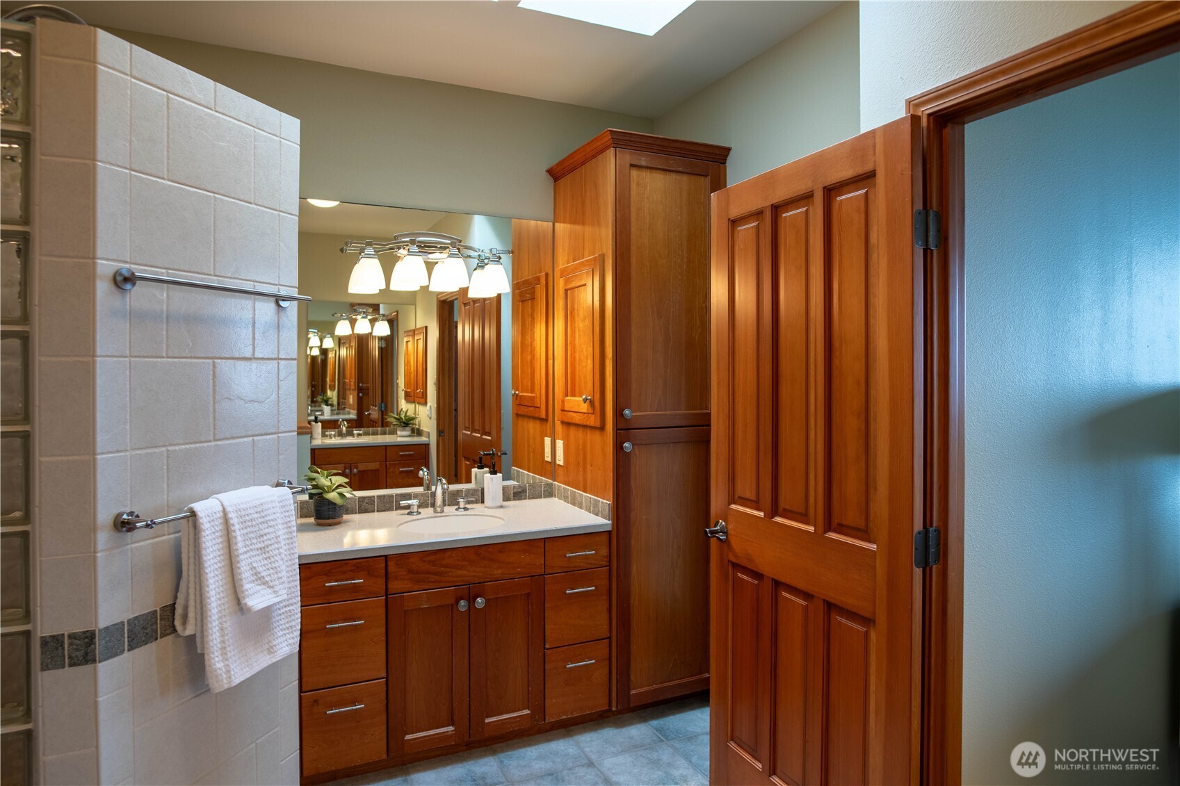 975 Simmons Road Port Angeles, WA 98362 - Photo 16 of 40 a bathroom with a double vanity sink mirror and shower