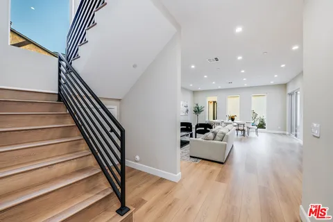 a view of entryway and hall with wooden floor