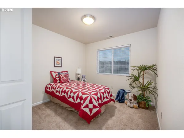 a bedroom with a bed next to a window
