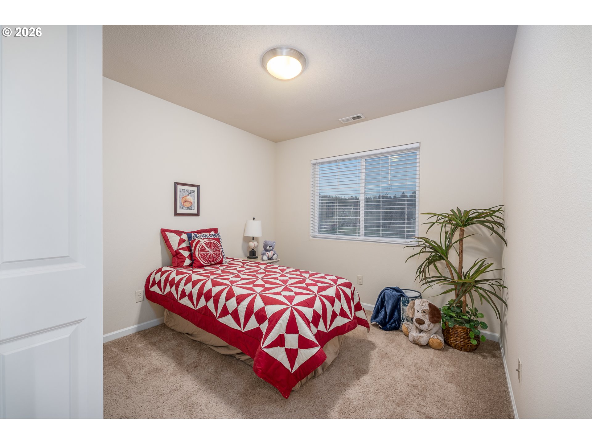 2976 Northwest Persimmon Way Albany, OR 97321 - Photo 16 of 29 a bedroom with a bed next to a window
