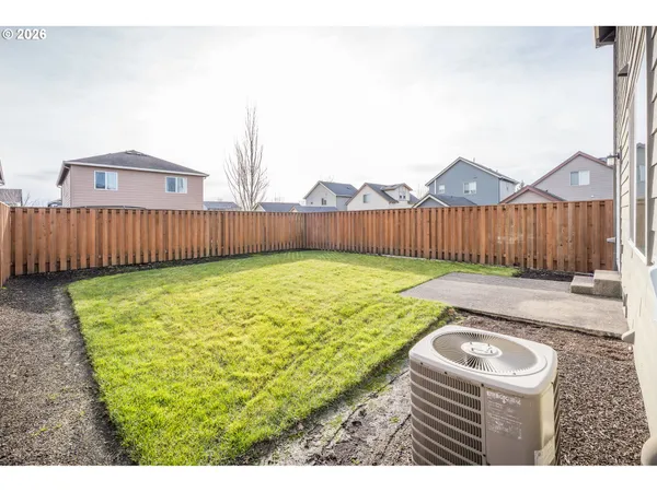 a view of swimming pool with a yard and wooden fence