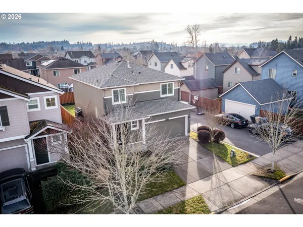 an aerial view of residential houses with outdoor space and ocean view