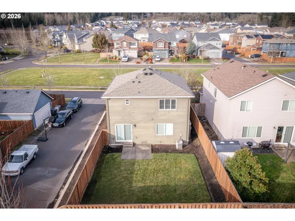 an aerial view of a house with a yard