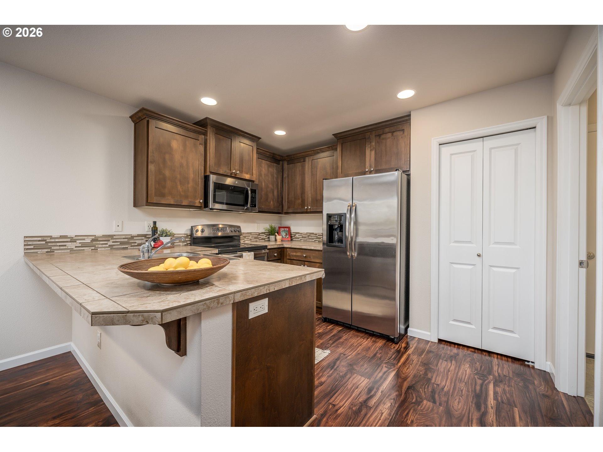 2976 Northwest Persimmon Way Albany, OR 97321 - Photo 8 of 29 a kitchen with stainless steel appliances granite countertop a sink stove and refrigerator