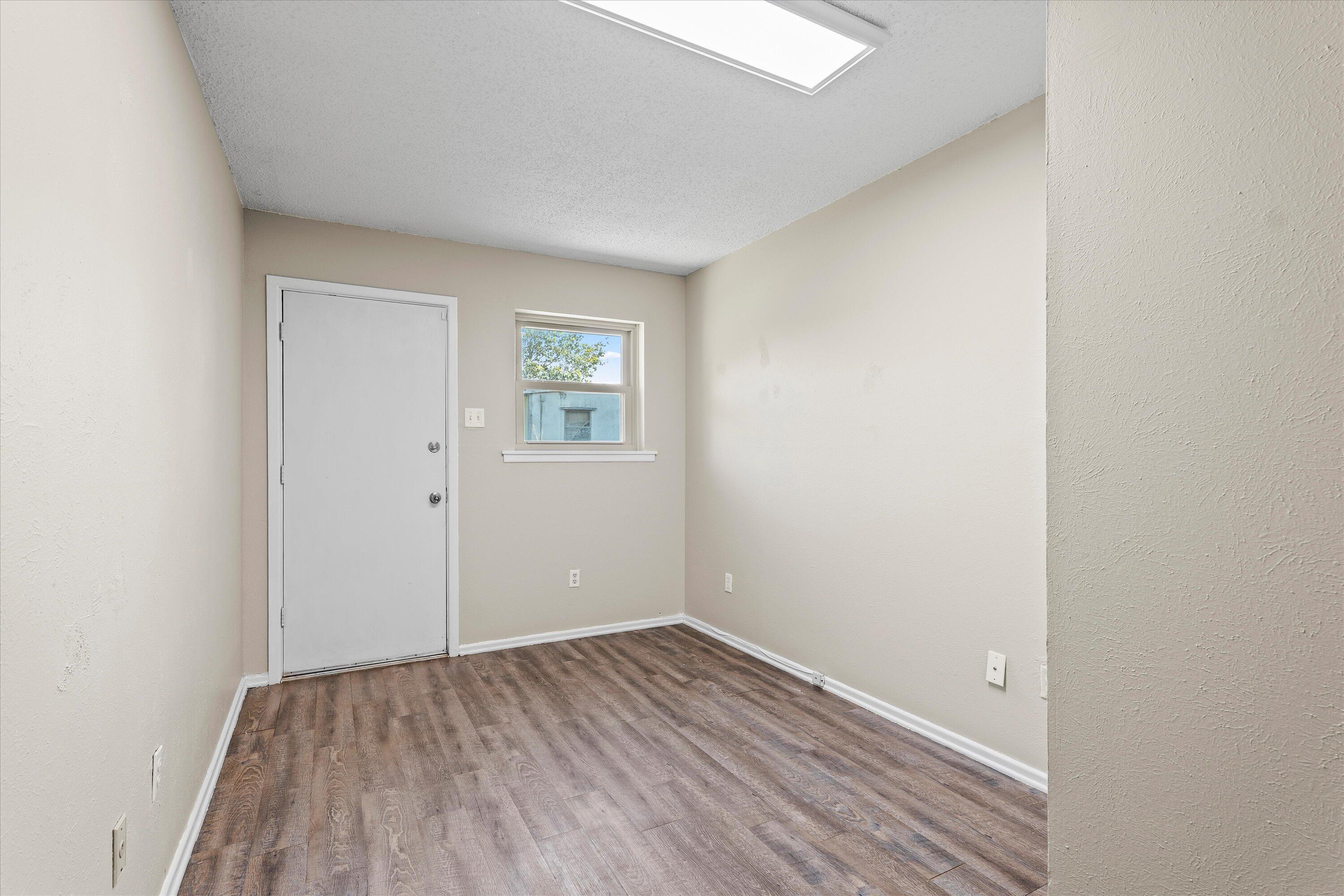 4520 54th Street Lubbock, TX 79414 - Photo 24 of 32 a view of an empty room with wooden floor and a window