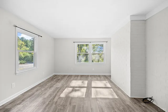a view of kitchen with wooden floor and electronic appliances