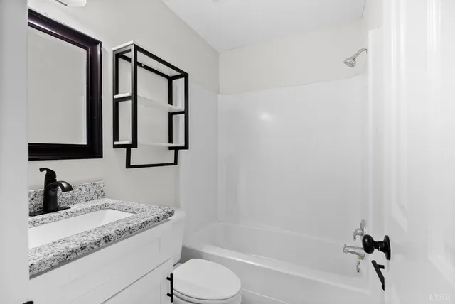 a view of an empty room with a fireplace