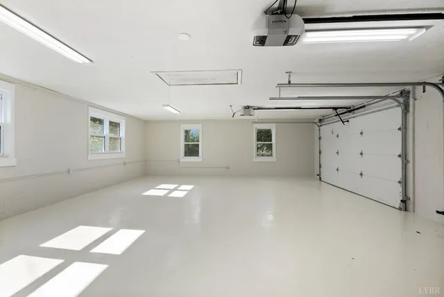 a view of a street with palm trees and a yard