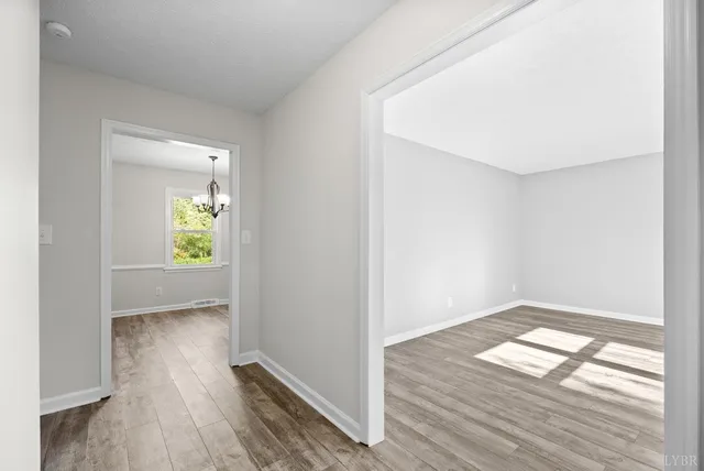 a view of a dining room with furniture wooden floor and a chandelier