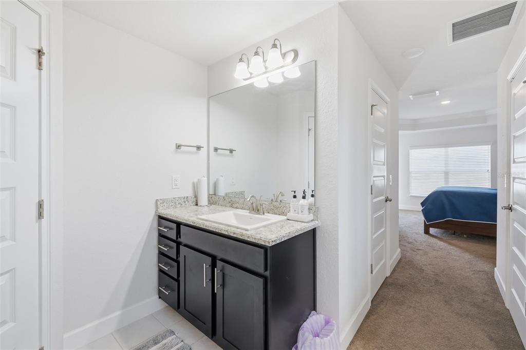 9144 Southeast 47th Court Road Ocala, FL 34480 - Photo 18 of 32 a en suite bathroom with a sink and a mirror