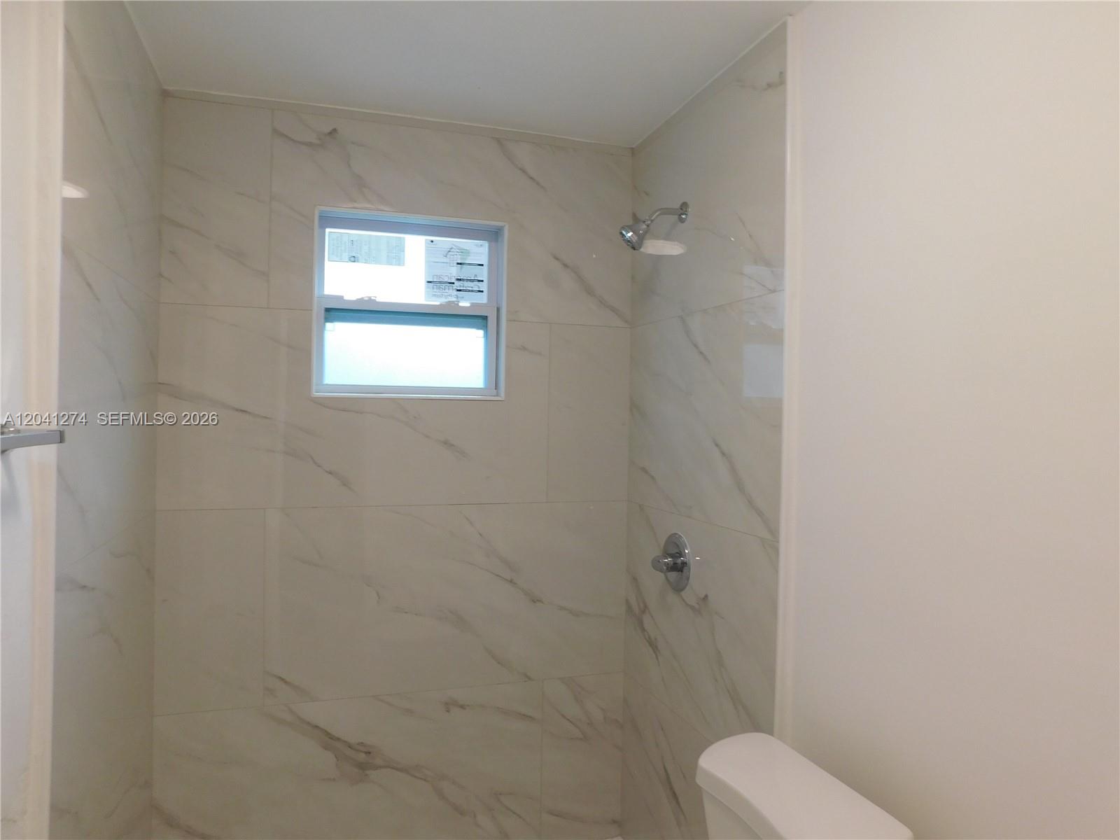 2230 Northwest 58th Street, Unit B Miami, FL 33142 - Photo 13 of 18 a bathroom with a toilet a sink and shower