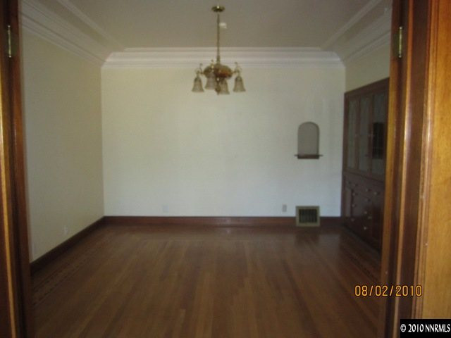 137 Burns Street Reno, NV 89502 - Photo 4 of 9 a view of an empty room with wooden floor and a window