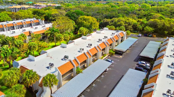 an aerial view of residential houses with outdoor space