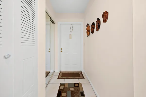 a hallway with white cabinets