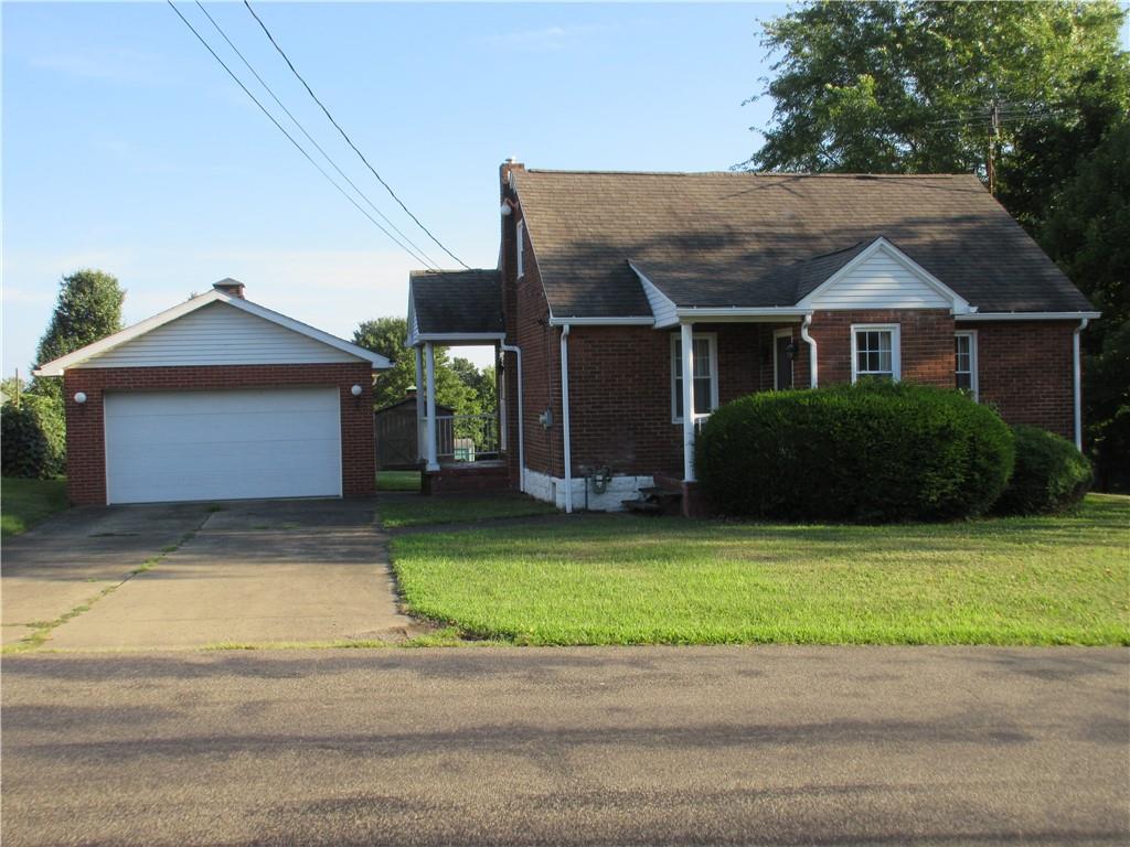 107 Blakely Road Butler, PA 16002 - Photo 1 of 25 a front view of a house with a garden and plants