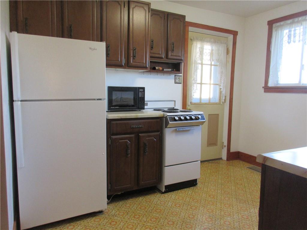 107 Blakely Road Butler, PA 16002 - Photo 4 of 25 a kitchen with a stove sink and a refrigerator
