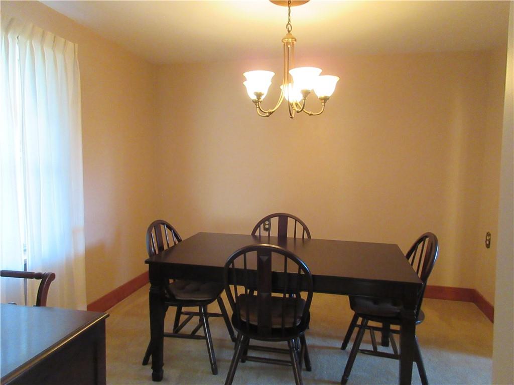 107 Blakely Road Butler, PA 16002 - Photo 8 of 25 a view of a dining room with furniture a chandelier and wooden floor