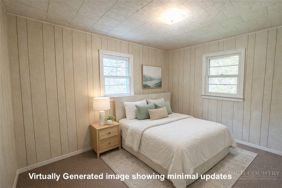 2510 Rich Hill Road Creston, NC 28615 - Photo 23 of 38 a bedroom with a bed a mirror and a window