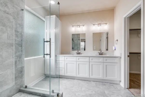 a bathroom with a double vanity sink and a mirror