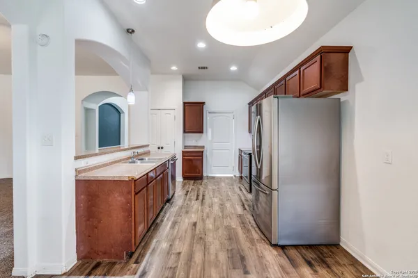 a kitchen with stainless steel appliances a refrigerator and a stove